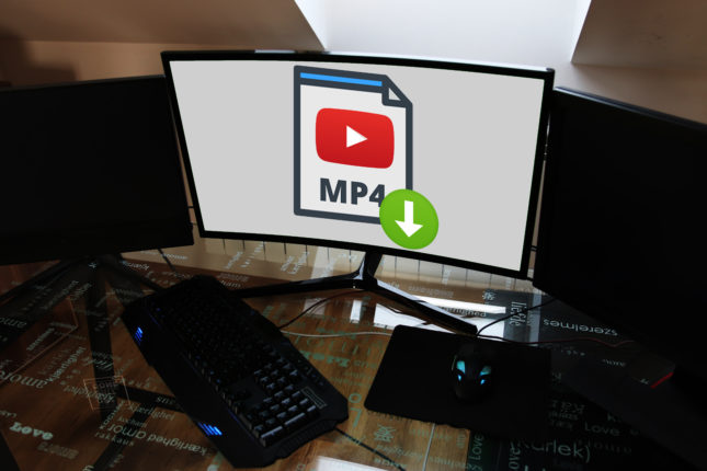 Komputer z monitorem na którym pobiera się film z YouTube